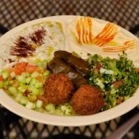 Veggie Mezza · Hummus, baba, falafel, tabouleh, Lebanese salad, grape leaves and pita. Served with pita bre...
