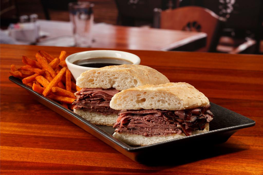 French Dip Sandwich · Roast beef, au jus and grilled hearth-baked French roll. Add cheese, mushrooms, caramelized onions for an additional charge.