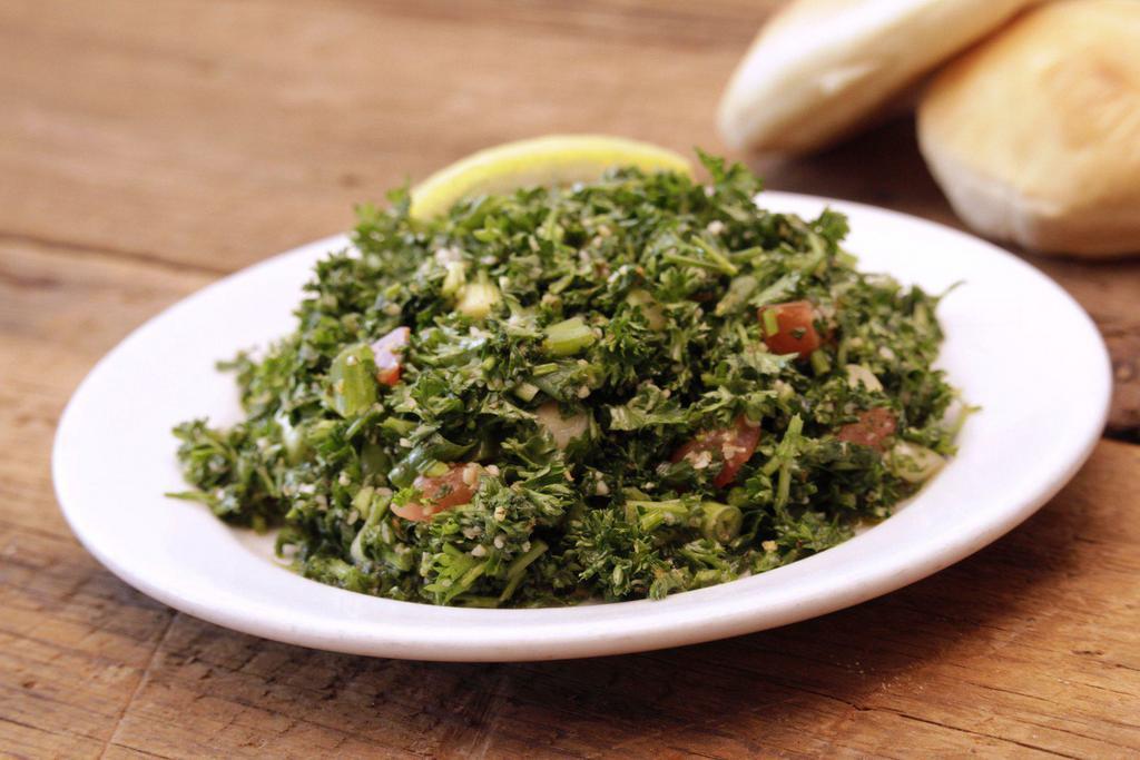 Tabbouli Salad · A chopped parsley salad with tomatoes, scallions, cracked wheat, lemon juice and herbs. Vegan.