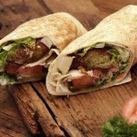 Falafel Vegetarian Sandwich · Falafel pieces with tahini sauce, lettuce, tomatoes and pickles. Vegan.