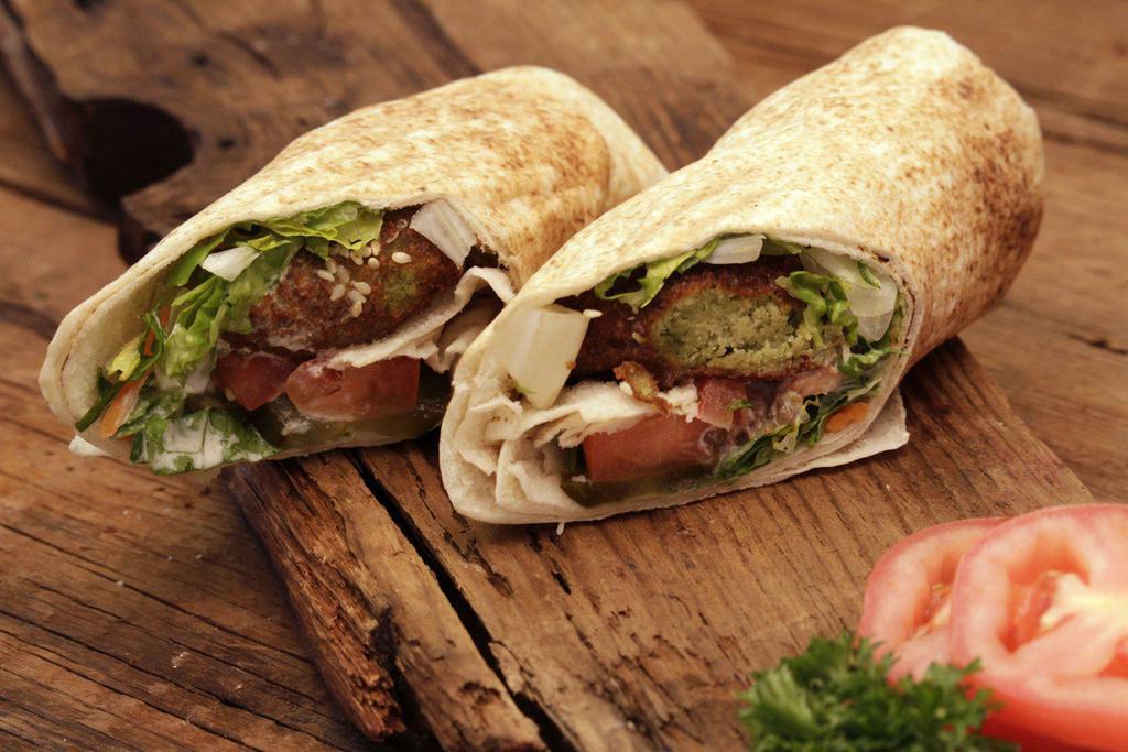 Falafel Vegetarian Sandwich · Falafel pieces with tahini sauce, lettuce, tomatoes and pickles. Vegan.