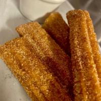 Choco Churros · Dusted in cinnamon sugar with a hazelnut dipping sauce.