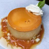 Guava Flan · Cream cheese caramel custard, pineapple brulee, sprinkled with toasted coconut flakes