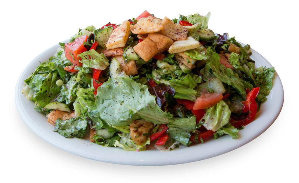 Fattoush Salad · Romaine lettuce, tomato, cucumber, bell peppers, red peppers, onions, herbs, pita chips and fatoush dressing.