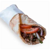 Beef Shawarma Wrap · Beef shawarma , Pita Bread , Onions , Tomatos  & Tahini Sauce 