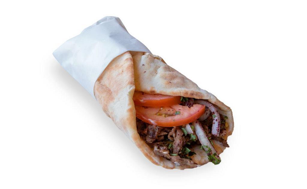 Beef Shawarma Wrap · Beef shawarma , Pita Bread , Onions , Tomatos  & Tahini Sauce 