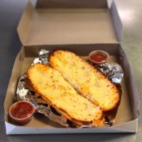 Garlic Bread · Fresh Italian bread lightly covered with our house made garlic butter and fresh chopped garl...