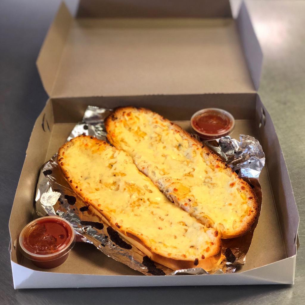 Garlic Bread · Fresh Italian bread lightly covered with our house made garlic butter and fresh chopped garlic served with marinara on the side, try it covered with mozzarella too