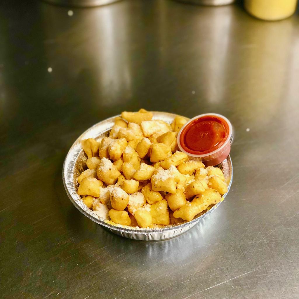 Garlic Bites · Lightly fried, bite sized pieces of dough covered in our house made garlic butter and Romano cheese, served with marinara on the side