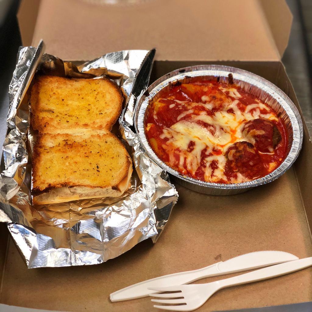 Stuffed Shells Dinner · Ricotta cheese filled shells with two meatballs topped with marinara sauce and mozzarella cheese then baked to perfection, served with a garlic bread on the side.