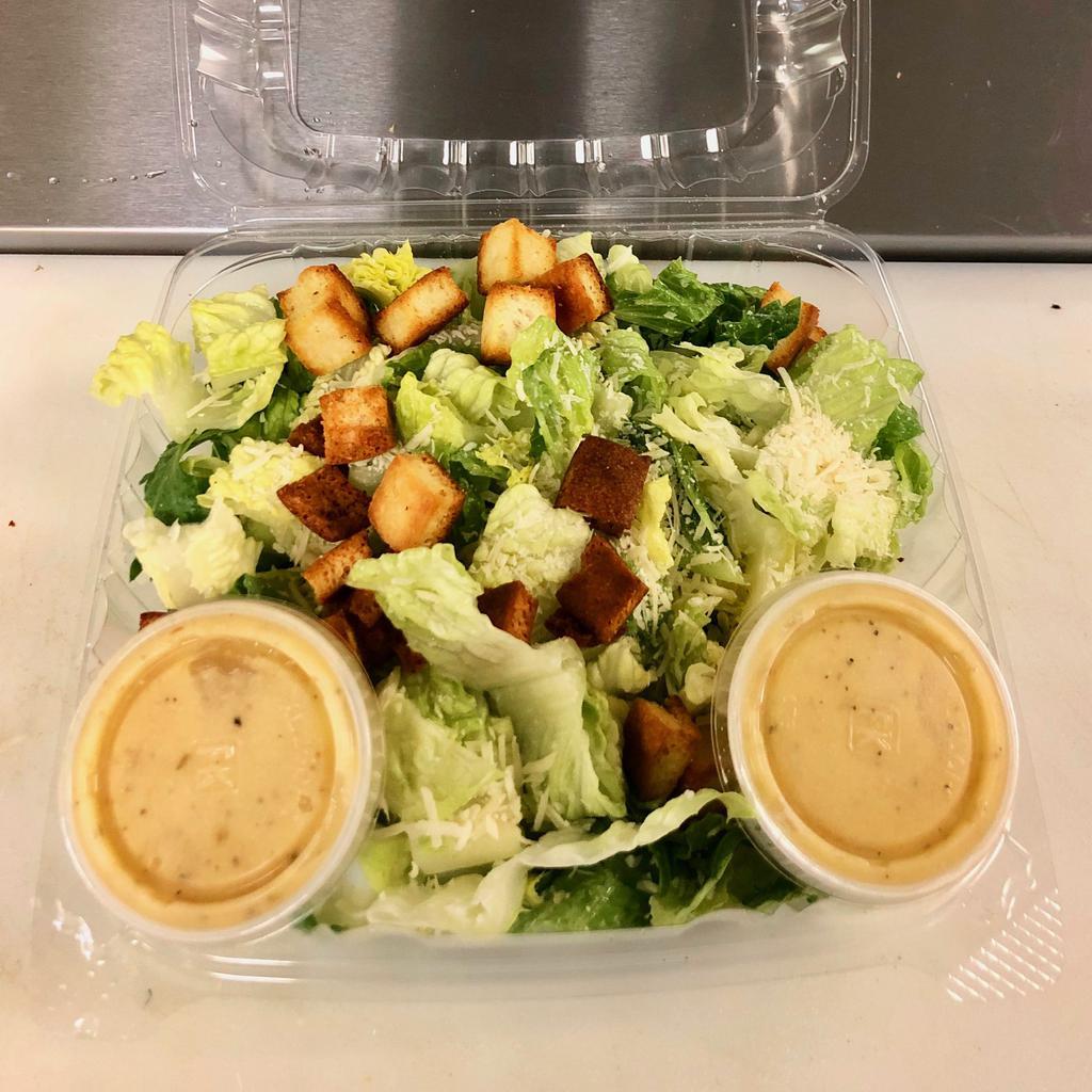 Caesar Salad · Our house made caesar salad served with fresh cut Romaine then topped with shredded asiago cheese and our house baked croutons with Ken's caesar Dressing on the side.