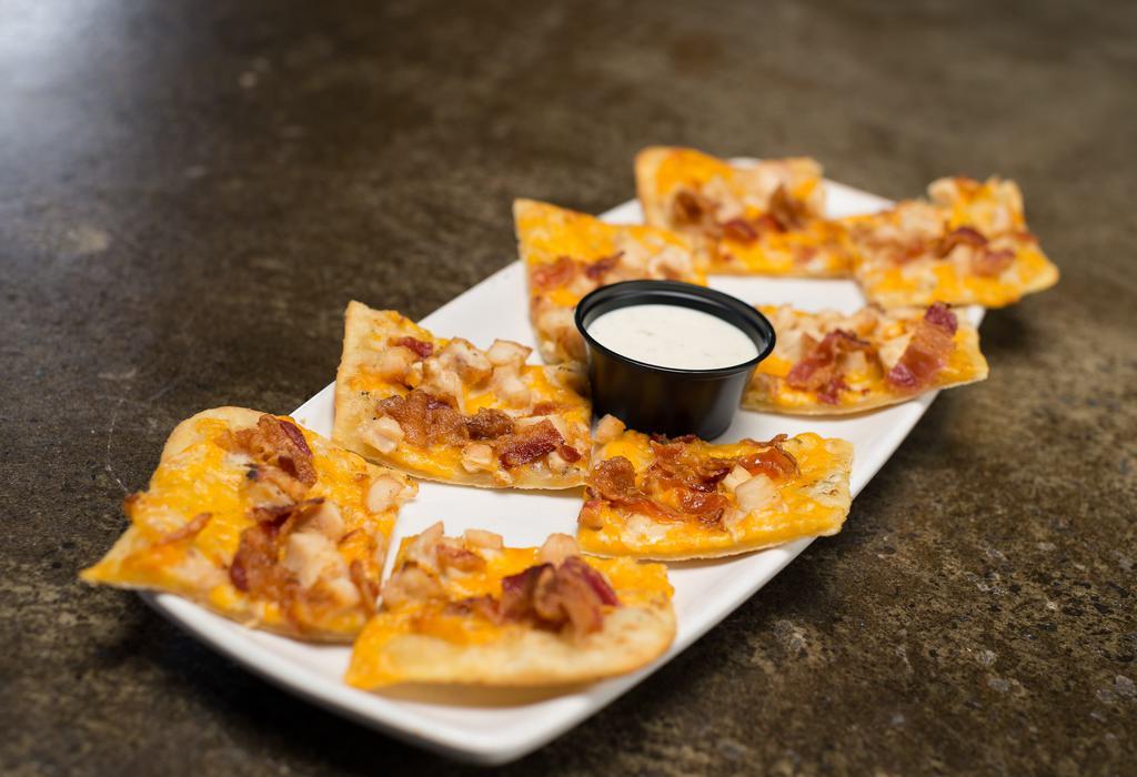 Chicken Bacon Ranch Flatbread · Grilled chicken breast, crisp bacon, creamy ranch and cheddar jack cheese on crispy flatbread. Served with ranch dressing.