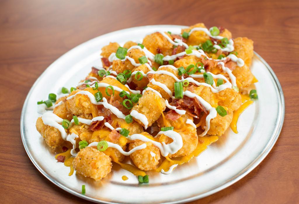 Loaded Tots · You gonna eat your tots? We serve 'em nice and crispy with cheddar jack cheese, bacon, sour cream and scallions.
