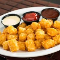 Tater Tots · Seasoned tater tots with just ketchup, queso and honey BBQ sides.