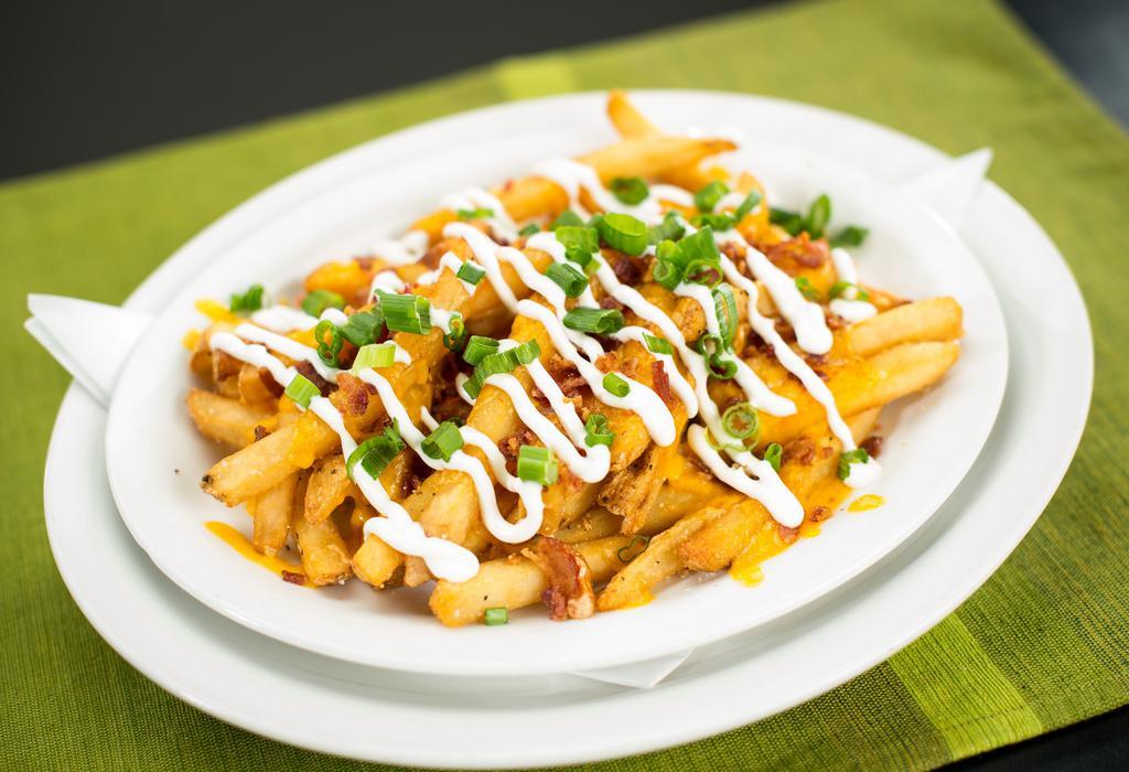 Loaded Fries · A large portion of our signature seasoned fries with cheddar jack cheese, bacon, sour cream and scallions.