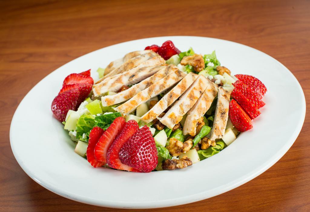 Chicken Apple Walnut Salad · Garden romaine topped with fresh Granny Smith apples, fresh strawberries, candied walnuts, bleu cheese crumbles, and freshly grilled chicken. Tossed with our citrus vinaigrette. It's as amazing as it sounds.