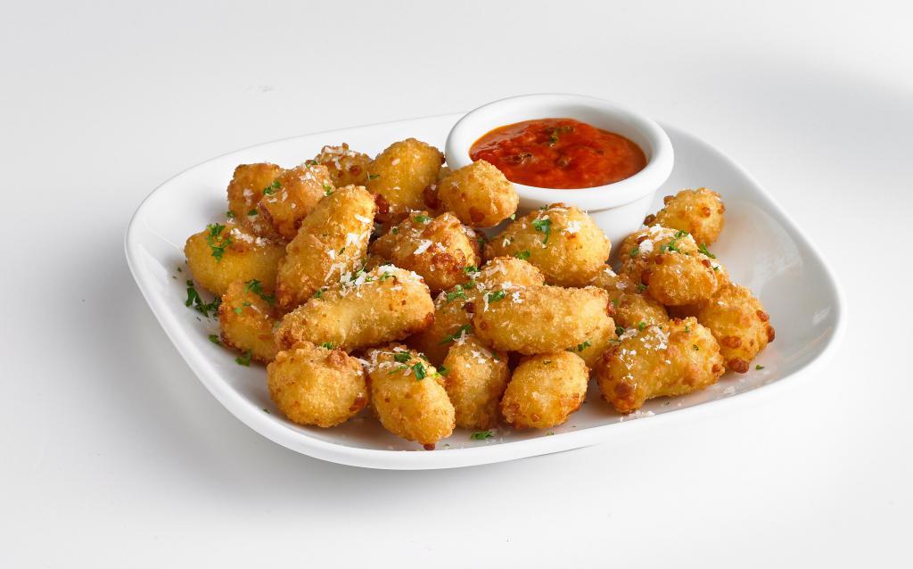 Cheese Curds · Wisconsin cheese curds lightly battered and fried to golden perfection. Served with a side of pomodoro sauce.