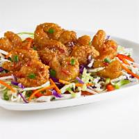 Thai Shrimp Bites · Breaded and fried shrimp tossed in an Asian glaze and served on shredded cabbage. Topped wit...