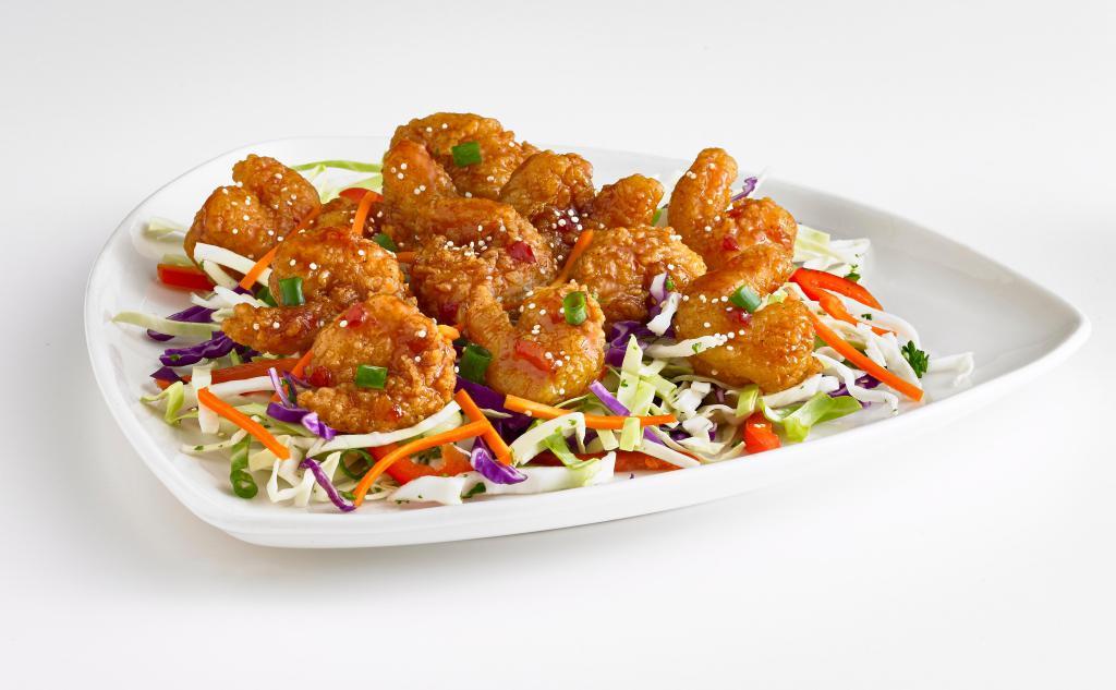 Thai Shrimp Bites · Breaded and fried shrimp tossed in an Asian glaze and served on shredded cabbage. Topped with carrots, green onions and sesame seeds.