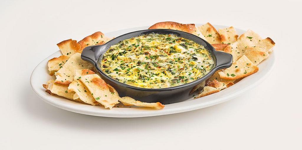 Spinach & Artichoke Dip · A made from scratch blend of creamy Alfredo sauce, fresh spinach, artichoke hearts, and a mix of cheeses. Served with handmade bread. Serves 3-4.