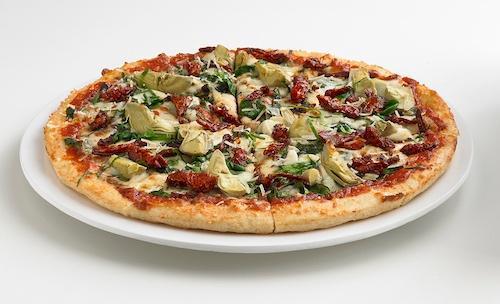 Florentine Pizza · Fresh spinach, artichokes, sun-dried tomatoes, and roasted garlic topped with mozzarella and Parmesan cheeses. Finished with fresh basil. Vegetarian.