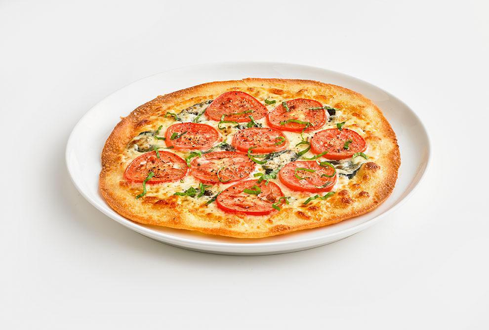 Margherita Thin Crust · Fresh basil, roasted garlic, sliced tomatoes, and mozzarella cheese.