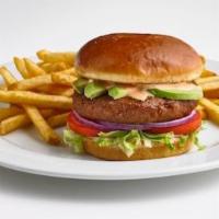 Beyond Burger · Beyond Meat® 100% plant-based burger patty on top of lettuce, tomatoes, red onions, and slic...