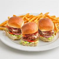 The MVB Sliders · Three miniature burgers topped with mozzarella cheese and bacon, served on a bed of lettuce ...