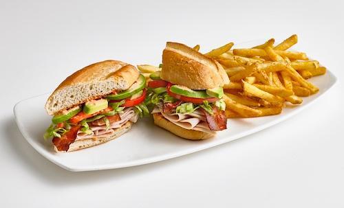 Turkey-Bacon-Avocado Sandwich · A premium turkey sandwich complete with mounds of sliced turkey breast, crispy bacon, sliced avocado, tomato, and shredded lettuce on a toasted hoagie roll with roasted red pepper aioli. Served with seasoned fries.