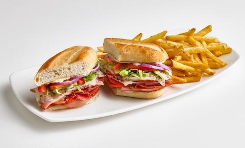 The Italian Brute · Oven roasted prosciutto, ham, pepperoni, and salami topped with melted mozzarella, Parmesan cheese, oregano, shredded lettuce, tomato, red onion, mayo, and zesty Italian dressing on a toasted hoagie. Served with seasoned fries.