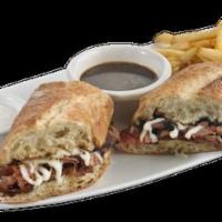 French Dip Sandwich · Thinly sliced roast beef and melted fontina cheese piled high on a toasted hoagie roll. Serv...