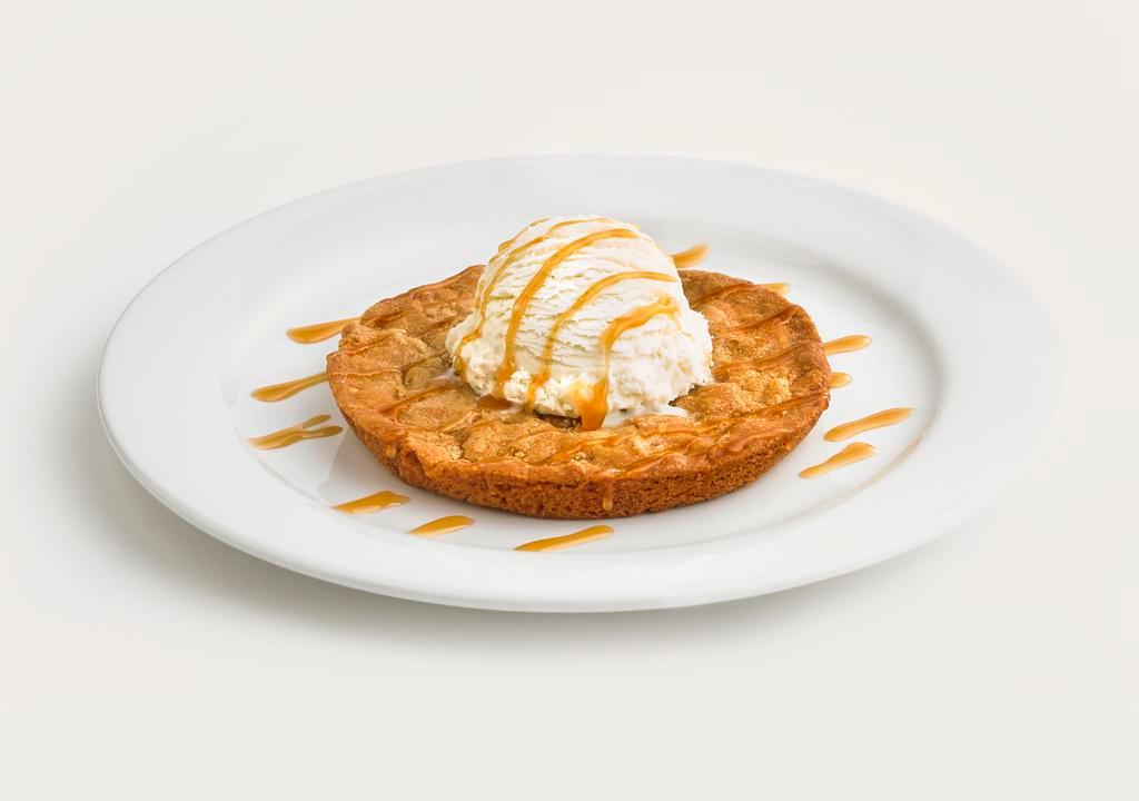Choose Your Monster Cookie · Your choice of a larger than life, chocolate chip or white chocolate macadamia nut cookie served hot with a scoop of vanilla ice cream.