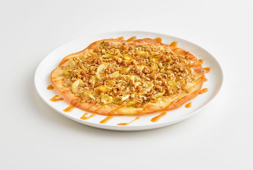 Apple Crisp Dessert Pizza · A dessert made entirely from scratch, featuring our handmade thin crust topped with brown sugar and cinnamon, rolled oats, sliced granny smith apples, and more brown sugar baked to a crumbly, decadent perfection. Great for sharing, but no one's saying you have to! 