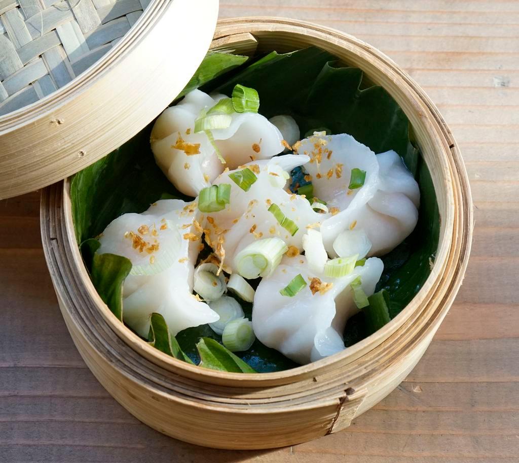 Steam veggie Dumpling · Steamed veggie dumpling topped with crunchy garlic ,Served with soy vinaigrette.