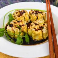 Steam chicken dumpling · Steam chicken dumpling topped with crunch garlic ,served with soy vinaigrette