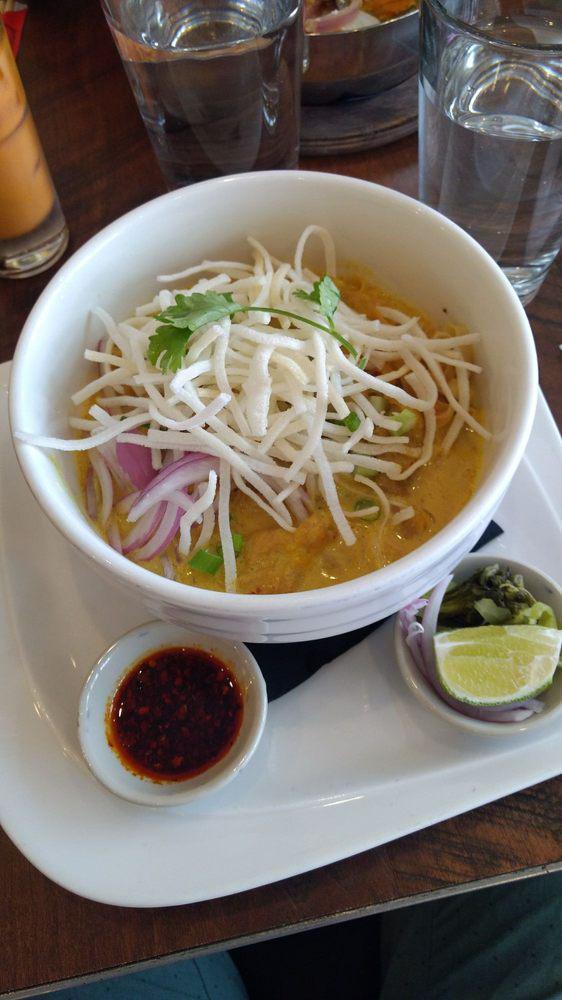 Kow Soi · Chicken. Northern Thai-inspired curry soup of herb flavor, shallots, garlic, cilantro, turmeric, curry powder, evaporated milk, fried shallot. Served with shredded chicken, egg noodle, top with crispy rice noodle.