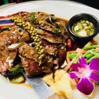 Sizzling Skirt Steak (16 oZ. ) with Thai Pepper Sauce · Grilled Marinated Skirt Steak with Thai black Pepper, white onion, and scallion