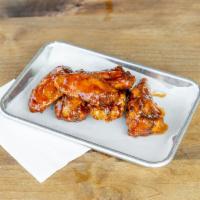Wingin It · Cooked wing of a chicken coated in sauce or seasoning.