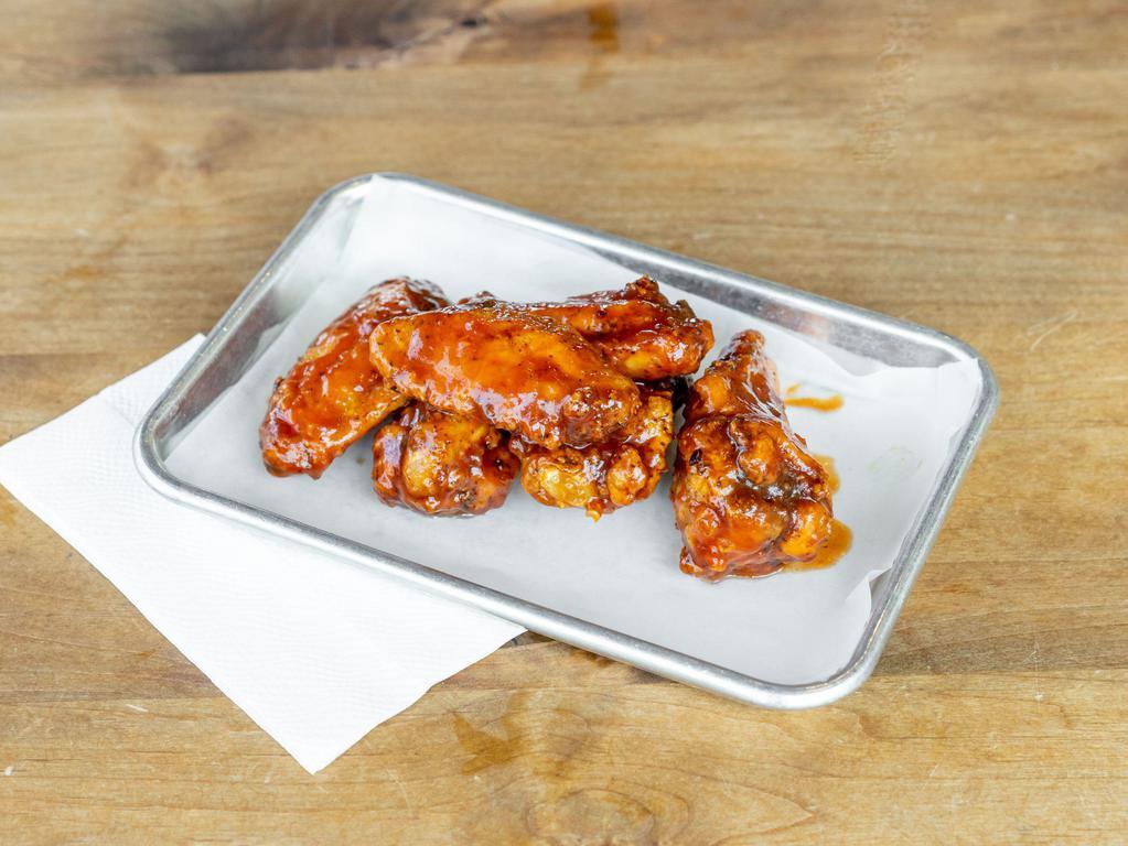 Wingin It · Cooked wing of a chicken coated in sauce or seasoning.