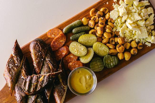 Pub Board · Soft pretzel, spanish chorizo, cornichon, aged cheddar, peruvian corn nuts, tony packo pickle