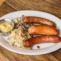 TWP's Wurst Sampler · Schaller and Weber's brat, knack and smoked, sauerkraut and warm potato salad.