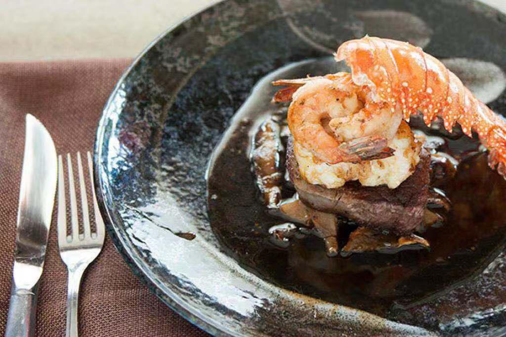 Surf and Turf Entree · Grilled filet Mignon, lobster tail and shrimp served with mushroom and truffle sauce.