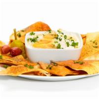 Whipped Feta · Our scratch-made feta dip, topped with honey and fresh parsley. Vegetarian.