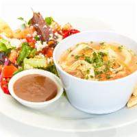 Greek Lemon Chicken Soup with Caesar Salad · Bowl of our homemade lemon chicken soup served with a side Caesar Salad.