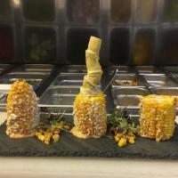 Elote Asado · Roasted corn, chipotle mayo & cotija cheese.
