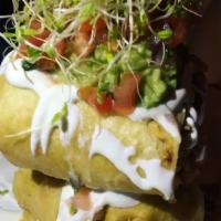 Pork Chimichangas · Fried burrito stuffed pork, rice, beans, cheese, sour cream, pico de gallo & guacamole