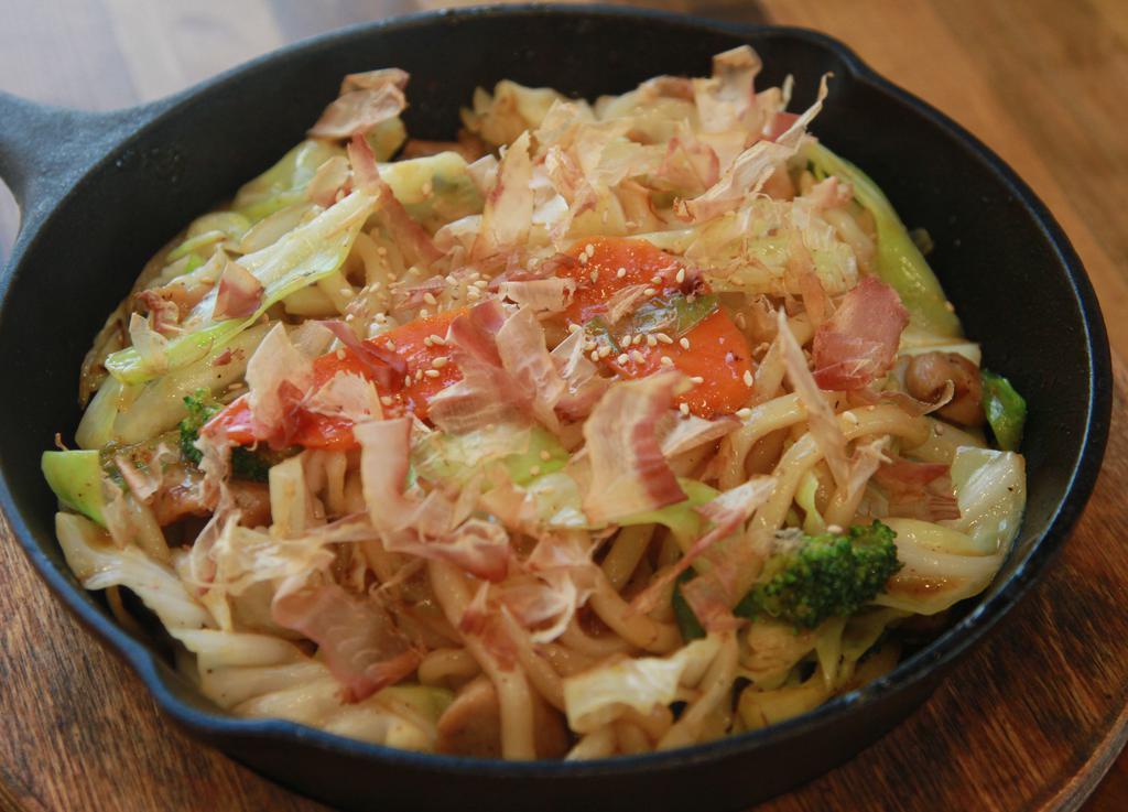 Yaki Udon · Yaki udon is a Japanese stir-fry dish consisting of thick, smooth, white udon noodles mixed with a soy based special sauce, choice of protein (chicken, beef, pork and shrimp), and vegetables. Topped with Katsuobushi (dried, fermented, and smoked bonito fish flakes)