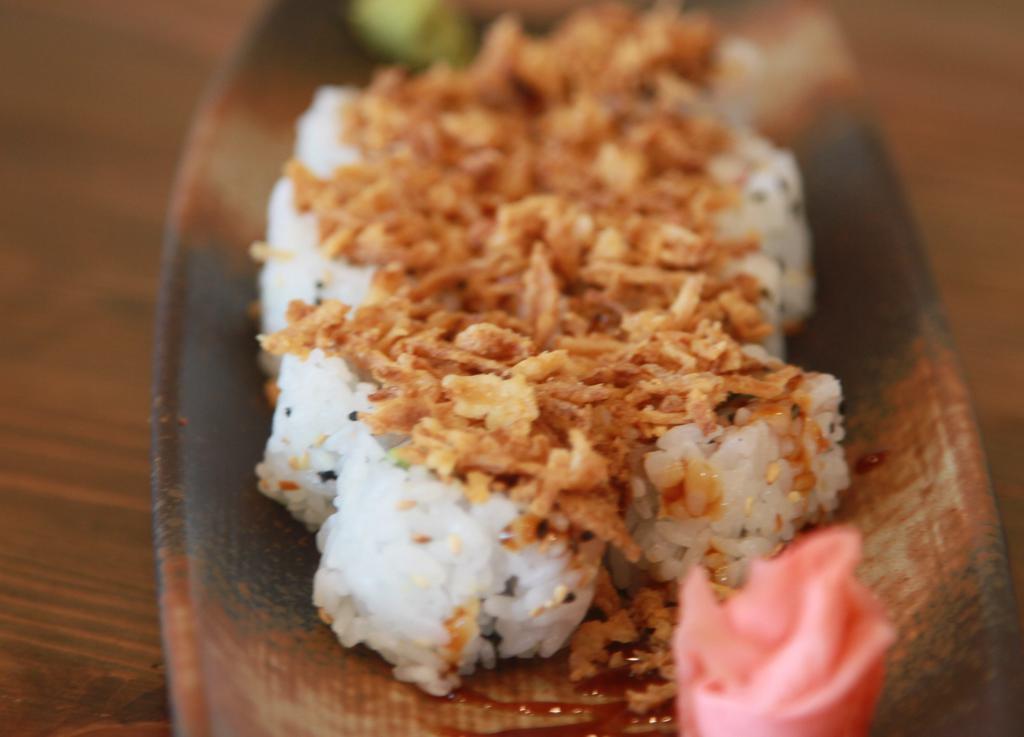 Crispy California Roll · Filled with avocado, crab meat and cucumber, topped with crispy onion chips and tare (sweet soy sauce).