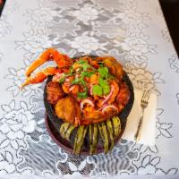Molcajete Volcan · Crab, shrimp, octopus, prawns and shells, sauteed in a homemade style salsa. 