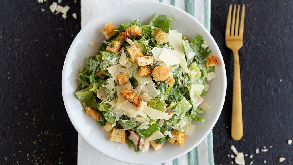 Classic Chicken Caesar Salad · Caesar salad topped with grilled chicken or Buffalo style chicken and Parmesan cheese.